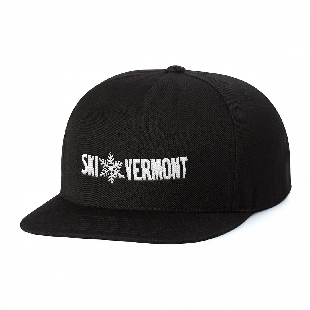 Black flat-brim hat featuring the “Ski Vermont” logo embroidered in white on the front. The design includes a snowflake graphic between the words “Ski” and “Vermont.”